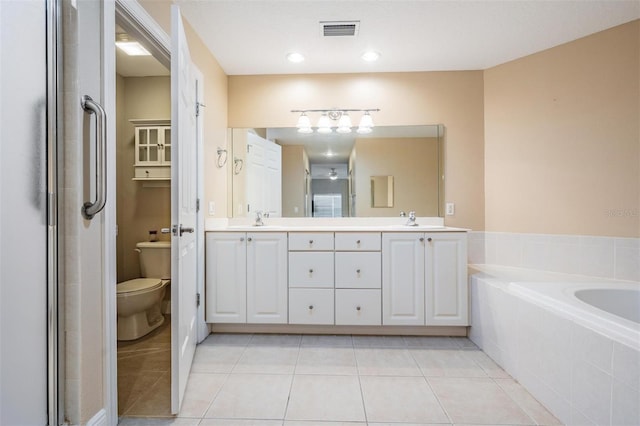 full bathroom with plus walk in shower, tile patterned flooring, vanity, and toilet