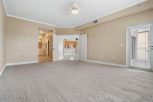 carpeted spare room with ceiling fan and ornamental molding