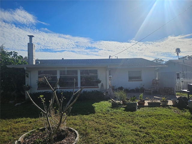 rear view of property with a yard