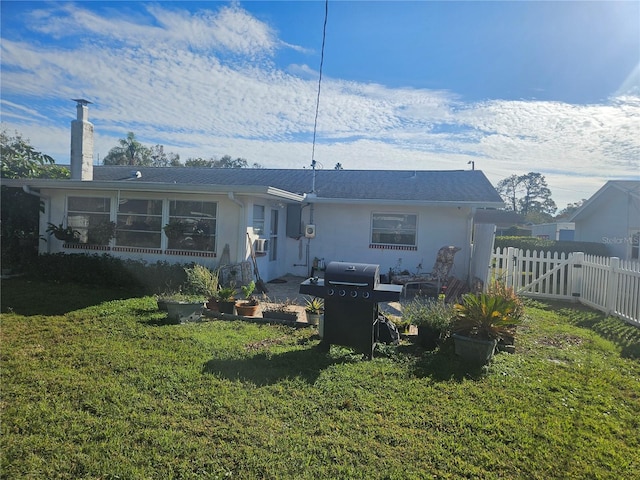 back of property featuring a lawn