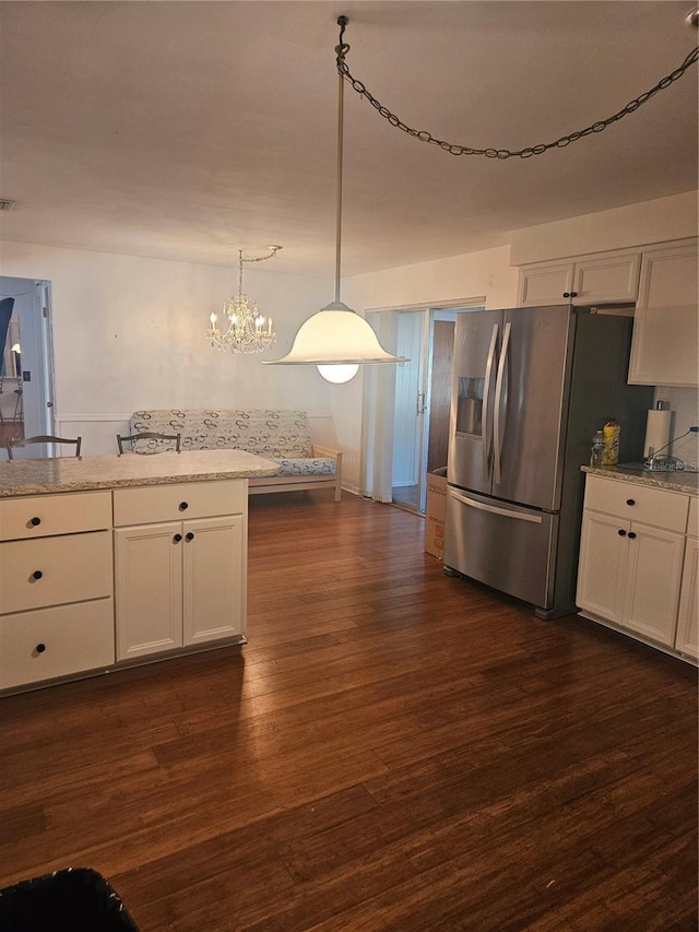 kitchen with stainless steel fridge with ice dispenser, white cabinets, and pendant lighting