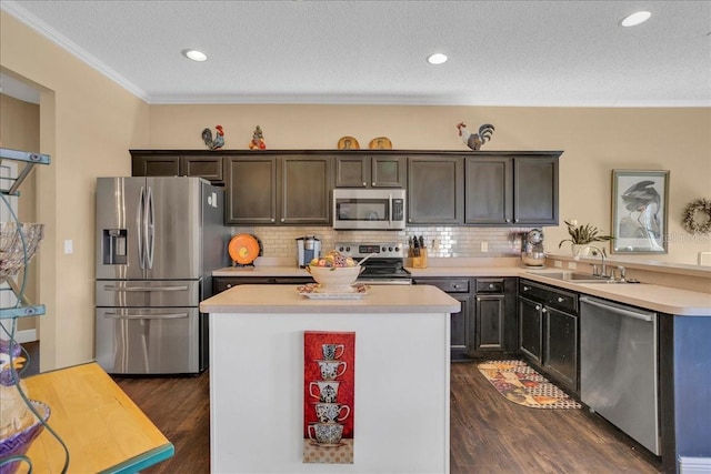 kitchen featuring appliances with stainless steel finishes, tasteful backsplash, dark brown cabinets, and sink