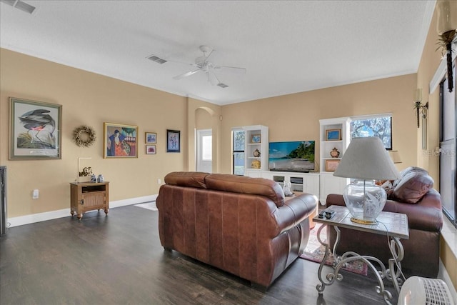 living room with a textured ceiling, dark hardwood / wood-style flooring, a wealth of natural light, and ceiling fan