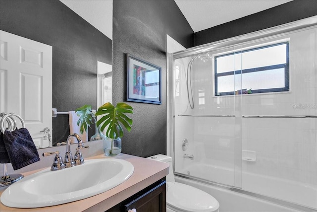 full bathroom featuring toilet, vanity, and combined bath / shower with glass door