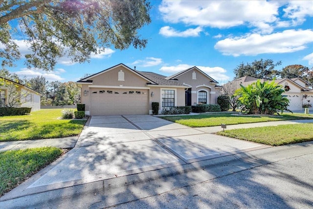 ranch-style home featuring a garage and a front lawn