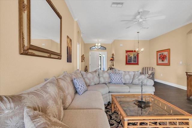 living room featuring a textured ceiling, ceiling fan with notable chandelier, crown molding, and dark wood-type flooring