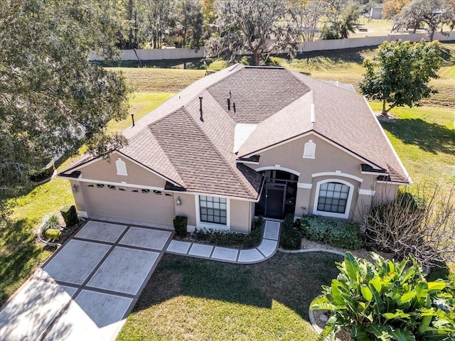 view of front facade featuring a garage and a front lawn