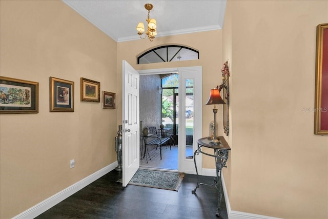 entrance foyer featuring a notable chandelier, dark hardwood / wood-style flooring, and ornamental molding