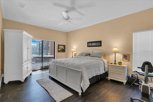 bedroom with a textured ceiling, access to outside, ceiling fan, and dark wood-type flooring