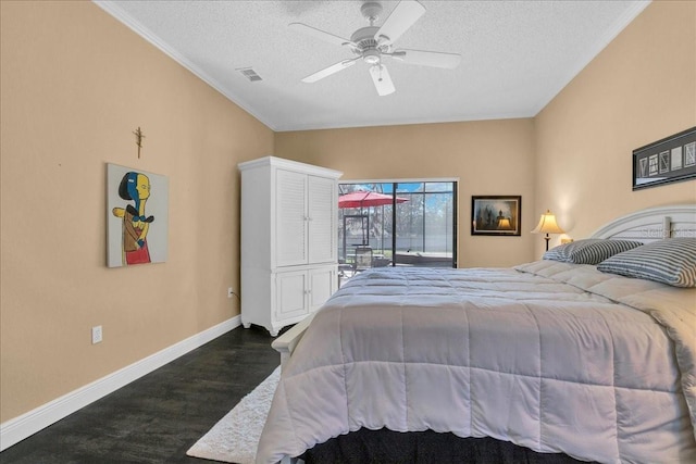 bedroom with ceiling fan, dark hardwood / wood-style flooring, and a textured ceiling