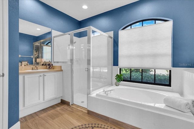 bathroom featuring separate shower and tub, vanity, and hardwood / wood-style flooring