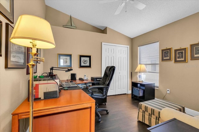 home office featuring a textured ceiling, vaulted ceiling, ceiling fan, and dark wood-type flooring