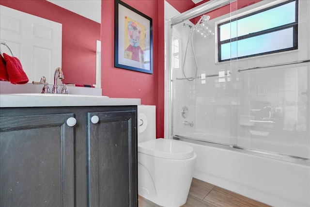 full bathroom with vanity, toilet, and enclosed tub / shower combo