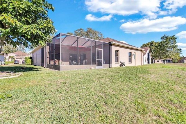 rear view of property with a lawn and a lanai