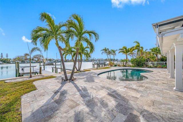 view of swimming pool featuring a dock, a patio area, and a water view