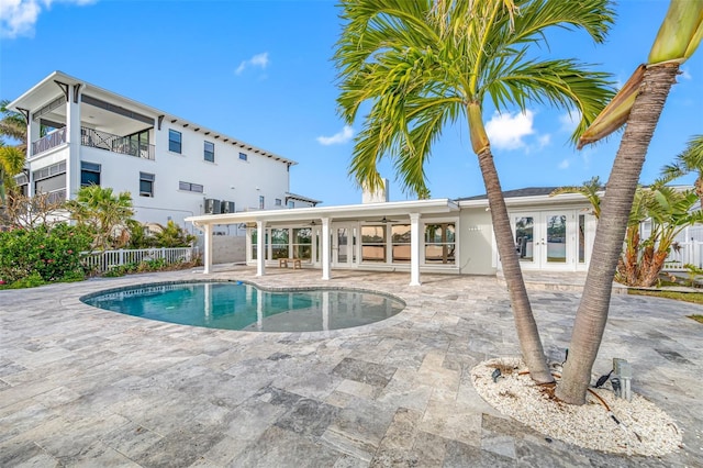 view of pool featuring a patio area, ceiling fan, and french doors