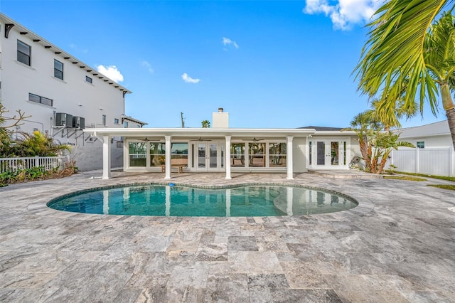 view of pool with ceiling fan, french doors, a patio, and central AC unit