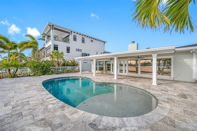 view of swimming pool with ceiling fan and a patio area