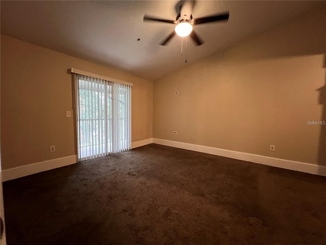 empty room with dark carpet, ceiling fan, and lofted ceiling