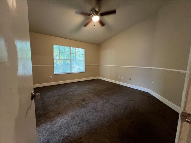 carpeted empty room with vaulted ceiling and ceiling fan