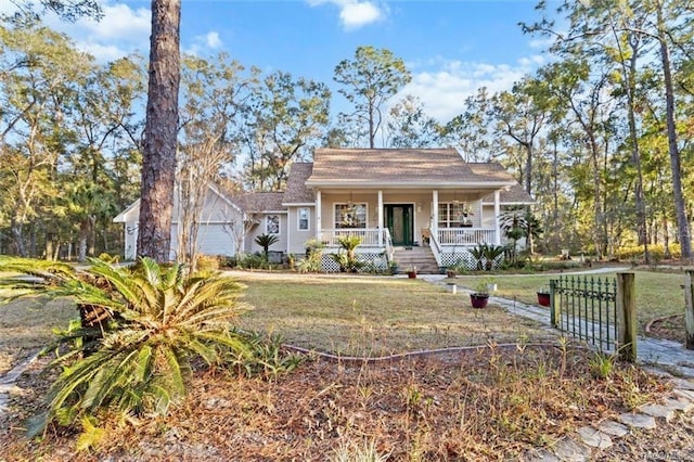 bungalow-style home with a front yard, a porch, and a garage