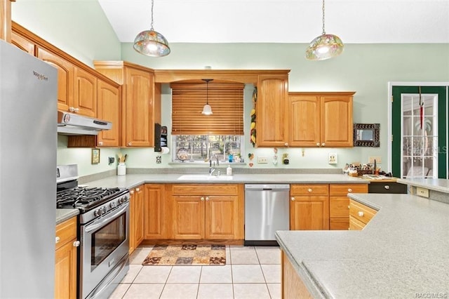 kitchen with appliances with stainless steel finishes, hanging light fixtures, and sink