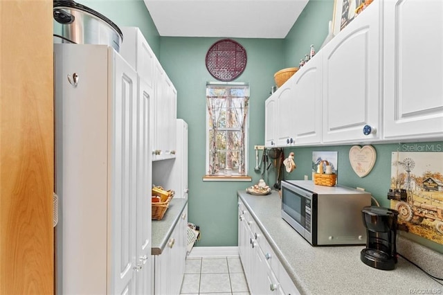 kitchen featuring white cabinetry and light tile patterned floors