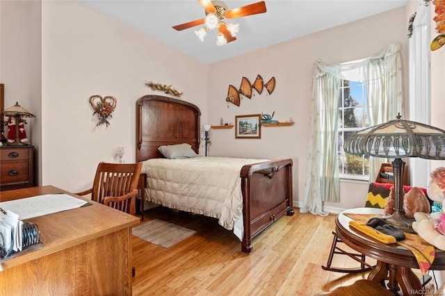 bedroom with ceiling fan and light hardwood / wood-style floors