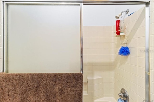 bathroom featuring a shower with door