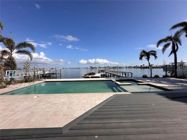 view of swimming pool featuring a water view and a boat dock