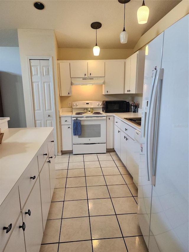 kitchen with white cabinets, light tile patterned floors, white appliances, and hanging light fixtures