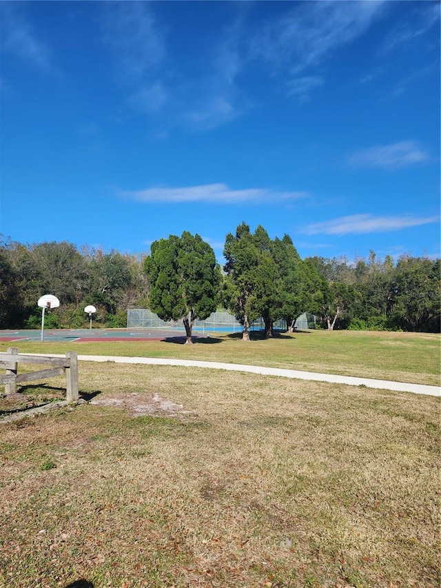 view of yard featuring basketball hoop