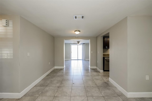 tiled spare room featuring ceiling fan