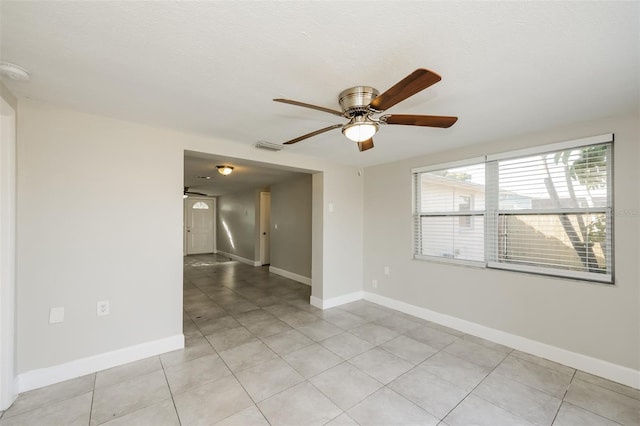 unfurnished room featuring ceiling fan and light tile patterned floors