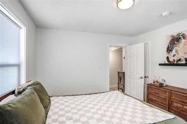 bedroom featuring multiple windows and a textured ceiling