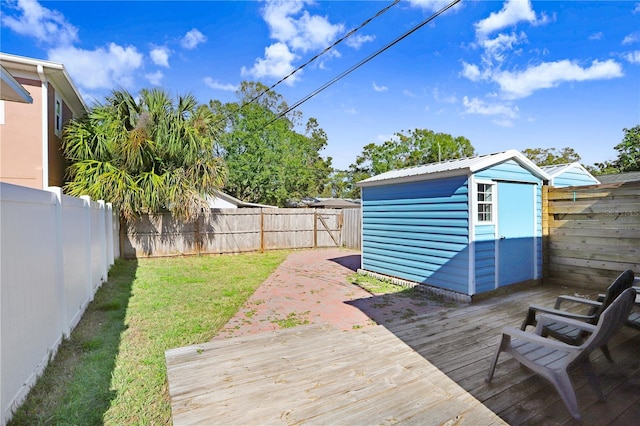 wooden terrace with a yard and a storage unit