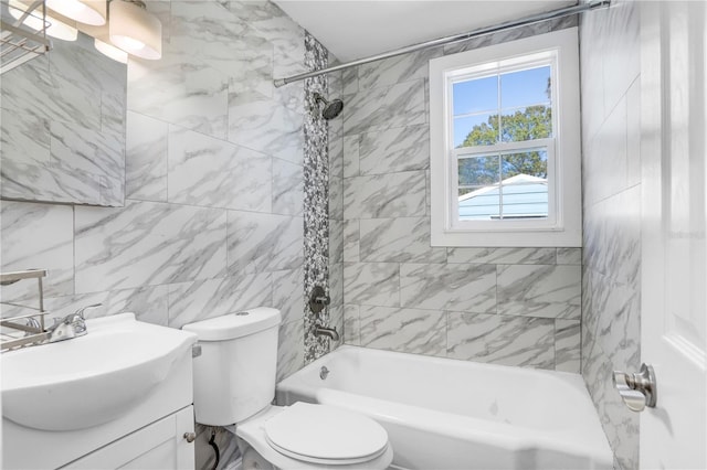 full bathroom featuring toilet, vanity, tile walls, and tiled shower / bath