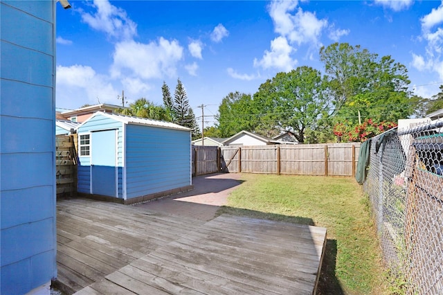 deck featuring a shed and a lawn