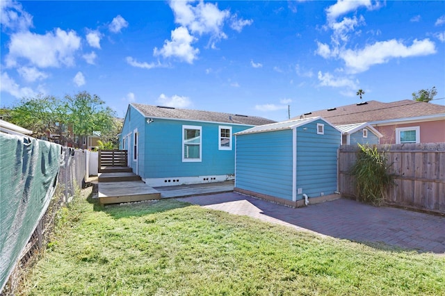 rear view of property with a lawn and a deck