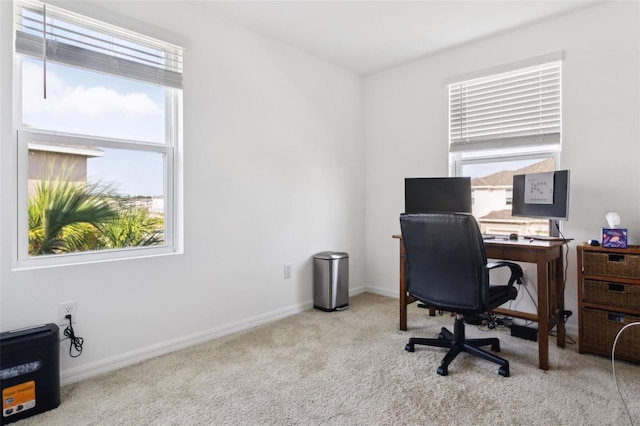 carpeted home office featuring baseboards