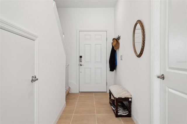 interior space with light tile patterned floors and baseboards