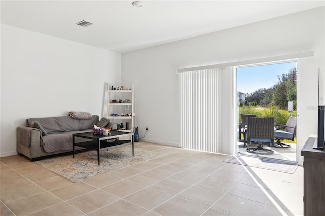 living room featuring light tile patterned floors and visible vents