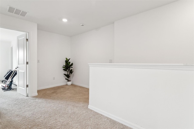 spare room with recessed lighting, visible vents, carpet floors, and baseboards