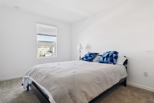 carpeted bedroom featuring baseboards