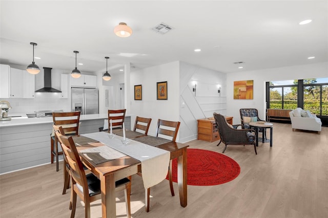 dining room with light hardwood / wood-style flooring and sink