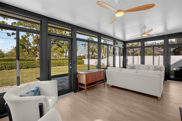 sunroom featuring ceiling fan and a wealth of natural light