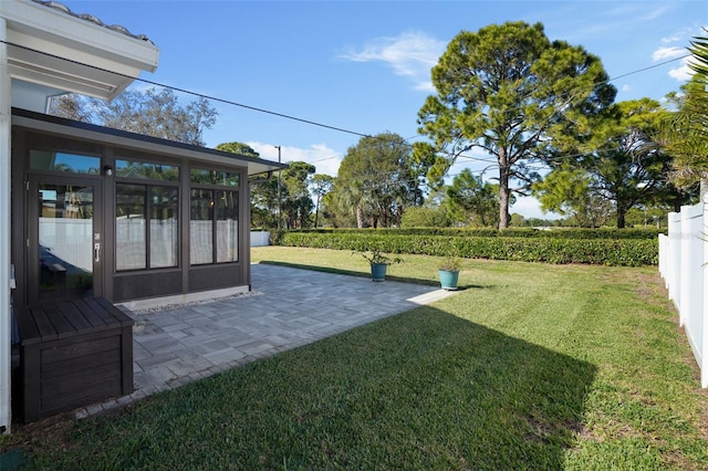 view of yard with a sunroom and a patio