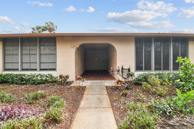 view of exterior entry with stucco siding