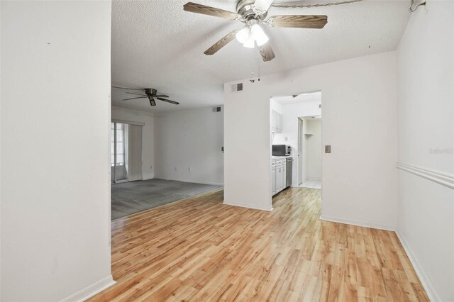 unfurnished room featuring light hardwood / wood-style floors and a textured ceiling