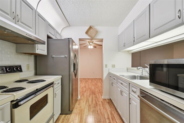 kitchen with white cabinets, sink, and appliances with stainless steel finishes